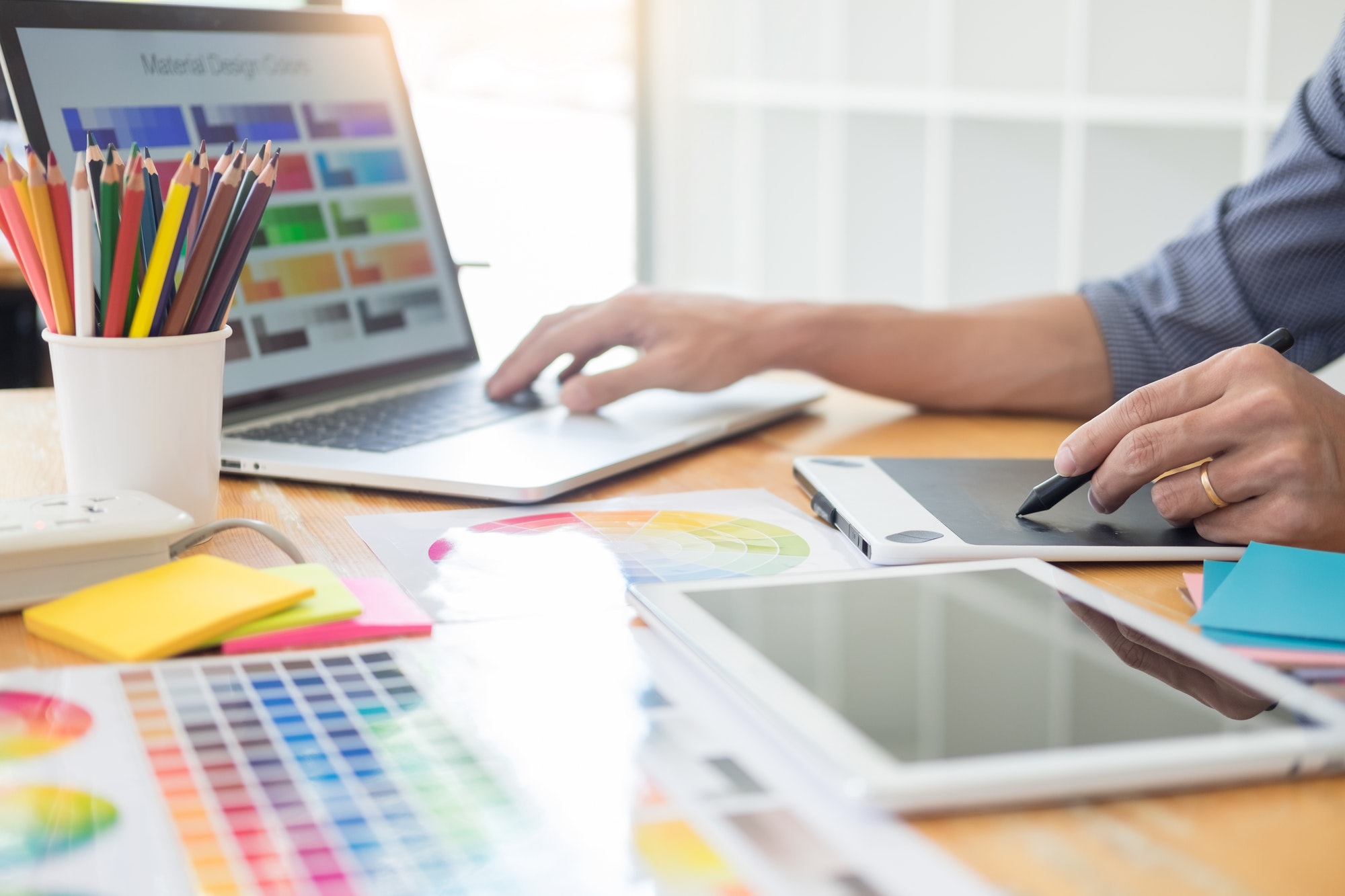 team interior designer drawing a new project using graphic computer and choosing Color swatch