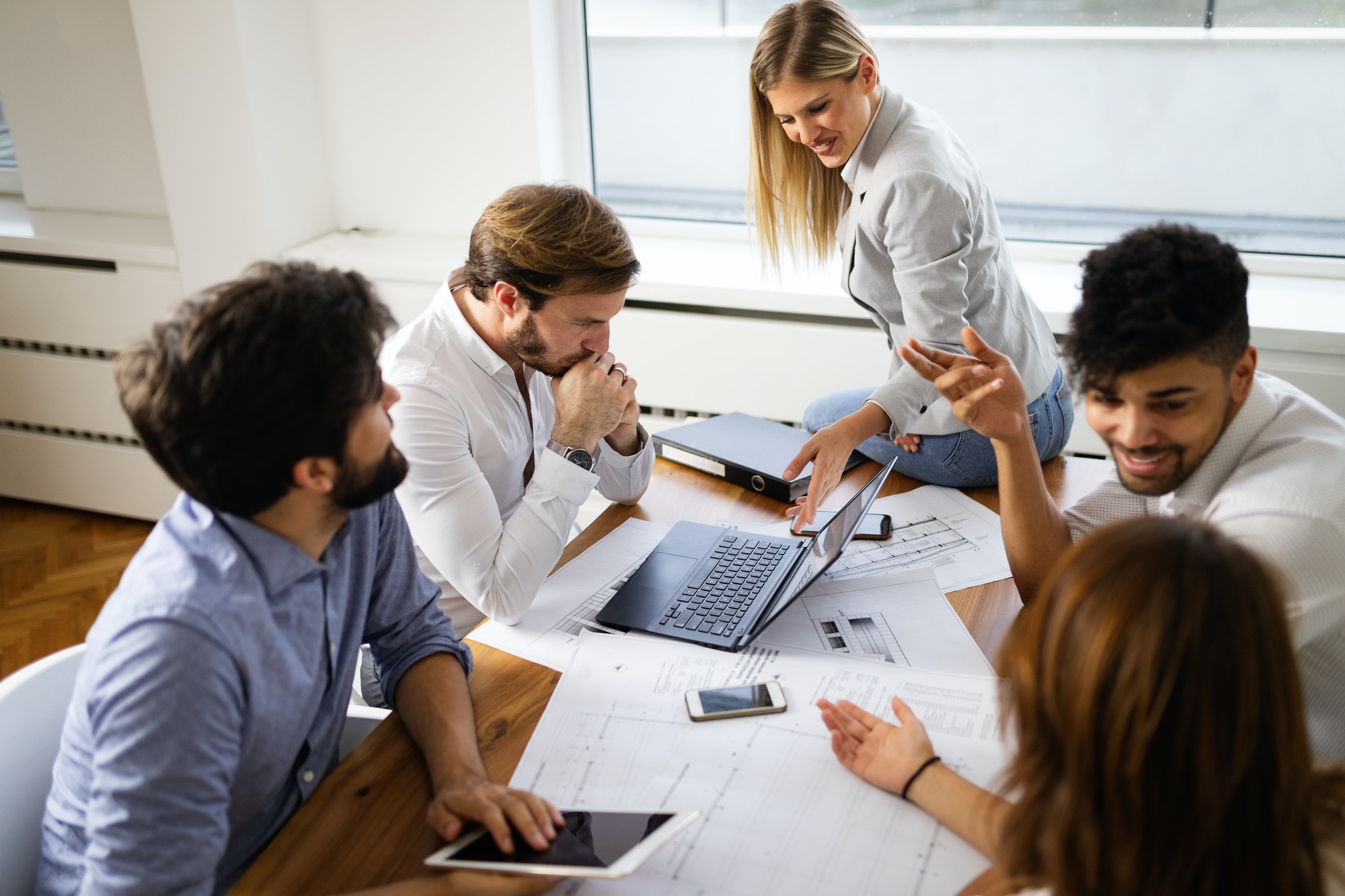 Team of architects working on construction plans in office