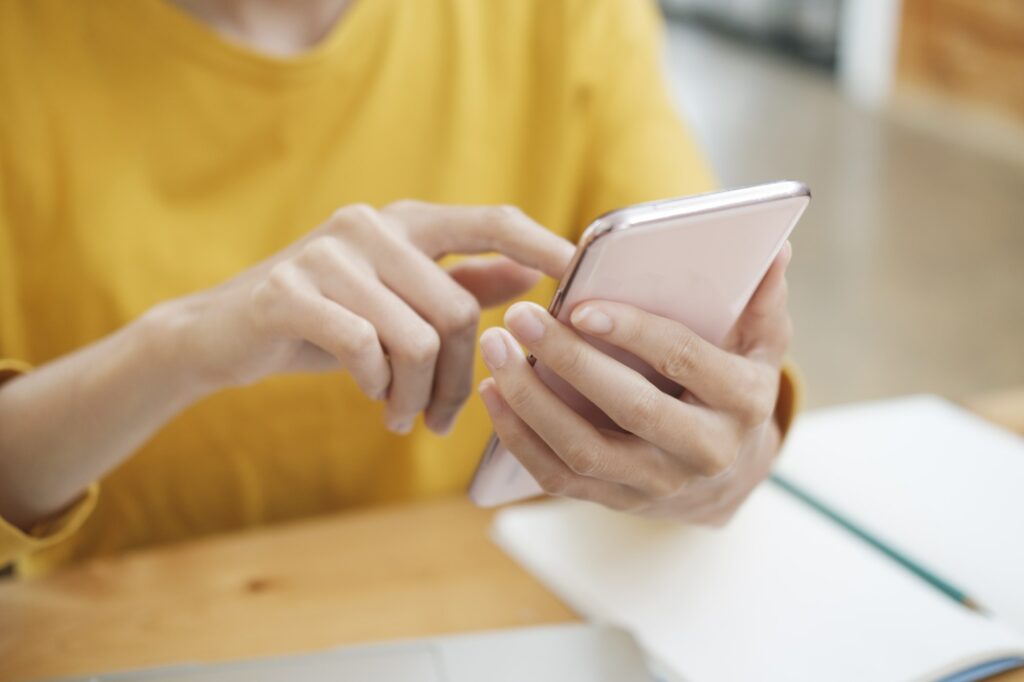 Close up of woman using mobile phone.