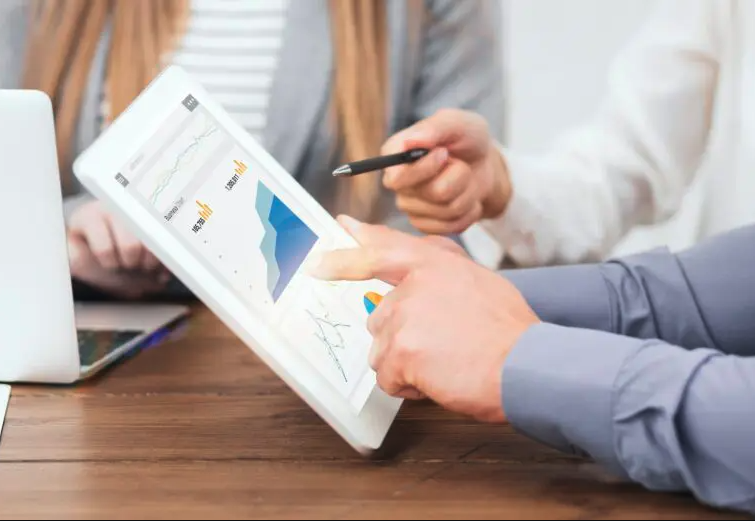 Two professionals analyzing data charts