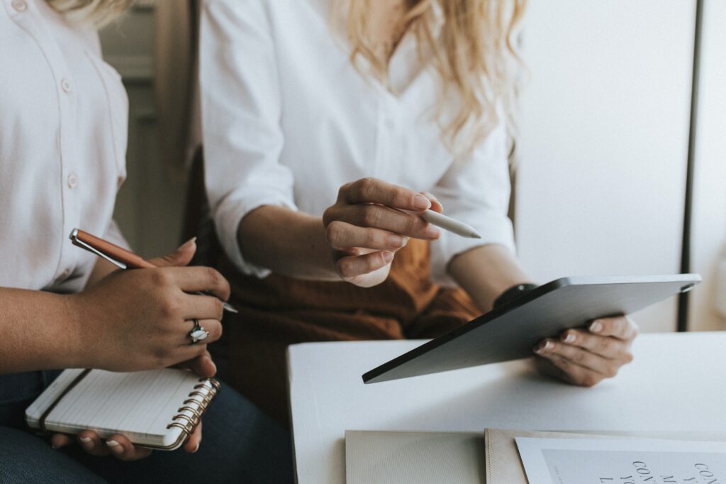 Two individuals sit at a table during a meeting